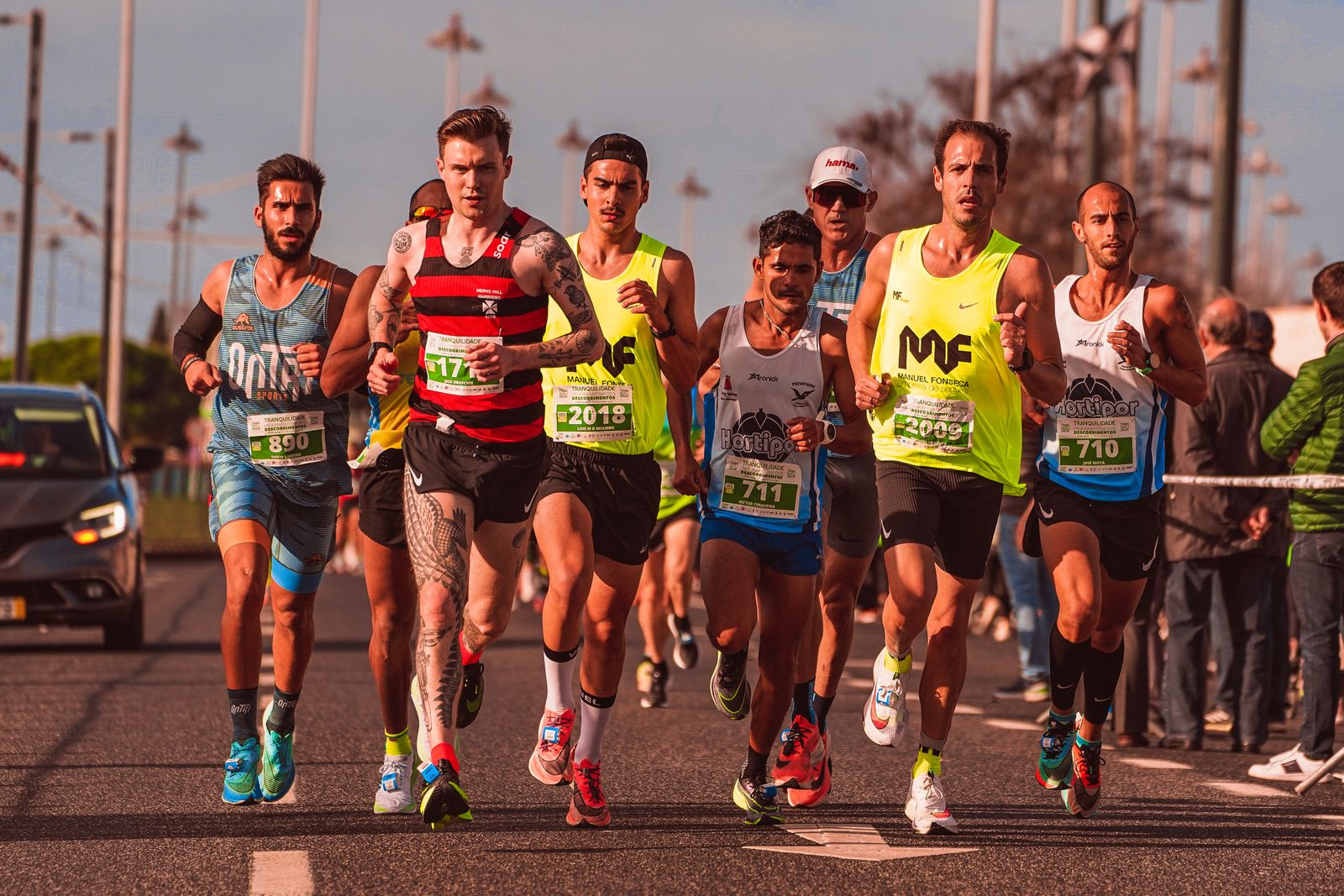 Corredores con número de carrera en una maratón por la calle